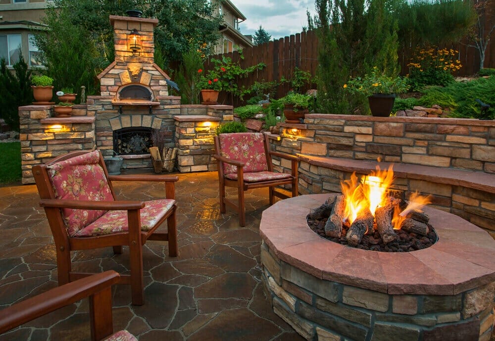 amazing backyard with pizza oven and fire pit Beautiful backyard at twilight that includes a pizza oven and fire pit.